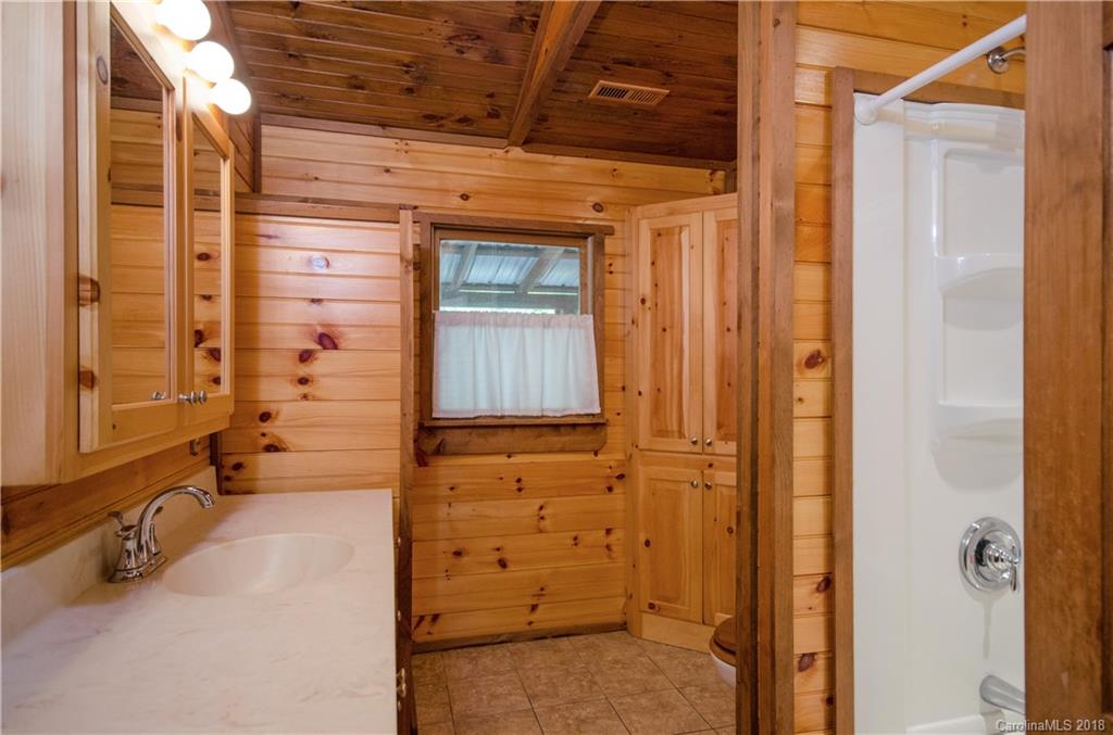 139 Stanley Ln Mill Spring, Unit 8 Mill Spring, NC 28756 - Photo 15 of 22 a view of a bathroom with a shower and a sink