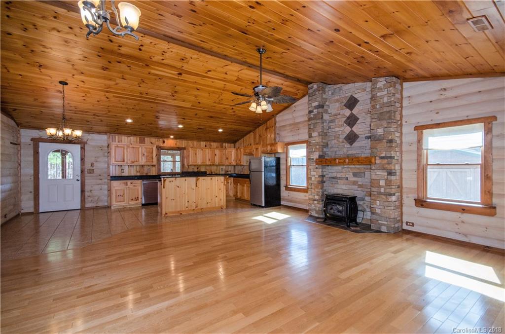 139 Stanley Ln Mill Spring, Unit 8 Mill Spring, NC 28756 - Photo 4 of 22 a view of empty room with wooden floor and fireplace