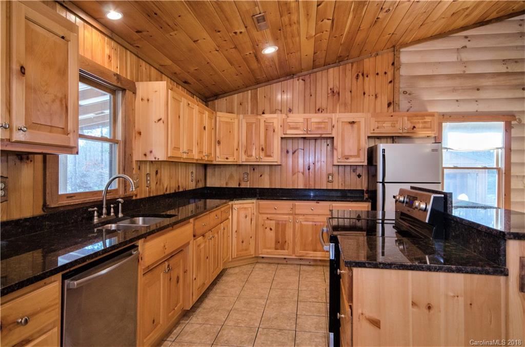 139 Stanley Ln Mill Spring, Unit 8 Mill Spring, NC 28756 - Photo 5 of 22 a kitchen with stainless steel appliances granite countertop a sink and cabinets
