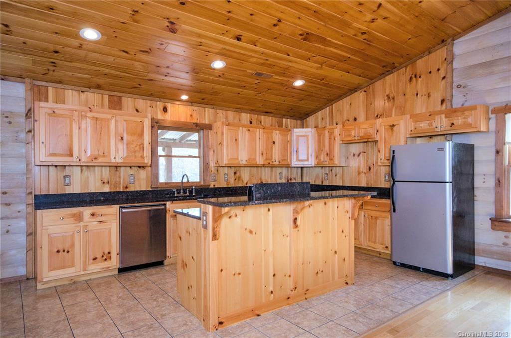 139 Stanley Ln Mill Spring, Unit 8 Mill Spring, NC 28756 - Photo 7 of 22 a kitchen with stainless steel appliances granite countertop a refrigerator a stove and a sink