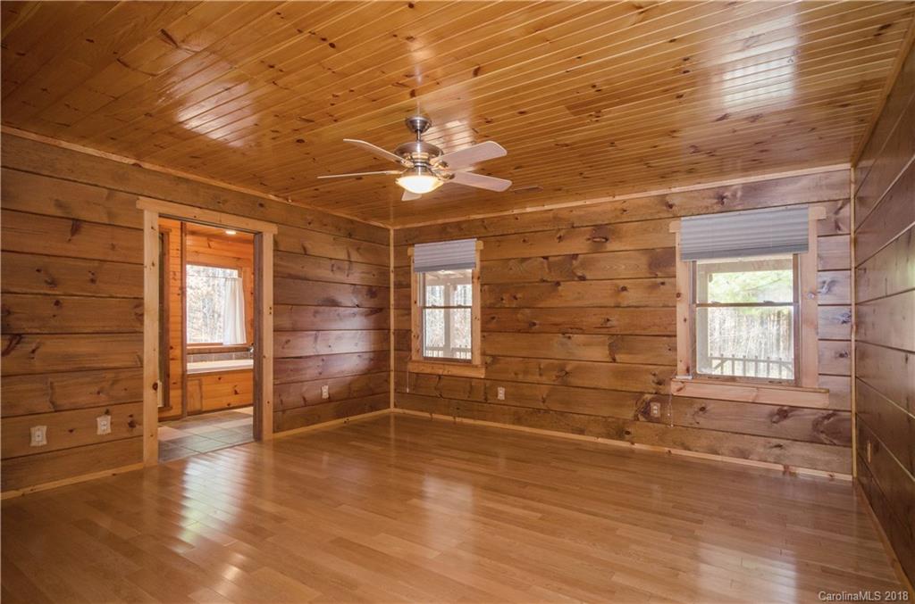 139 Stanley Ln Mill Spring, Unit 8 Mill Spring, NC 28756 - Photo 8 of 22 an empty room with wooden floor and windows