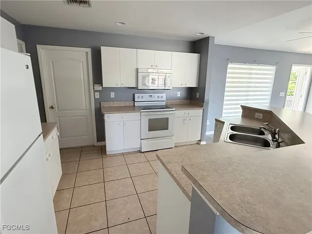 a kitchen with a stove a sink and a refrigerator