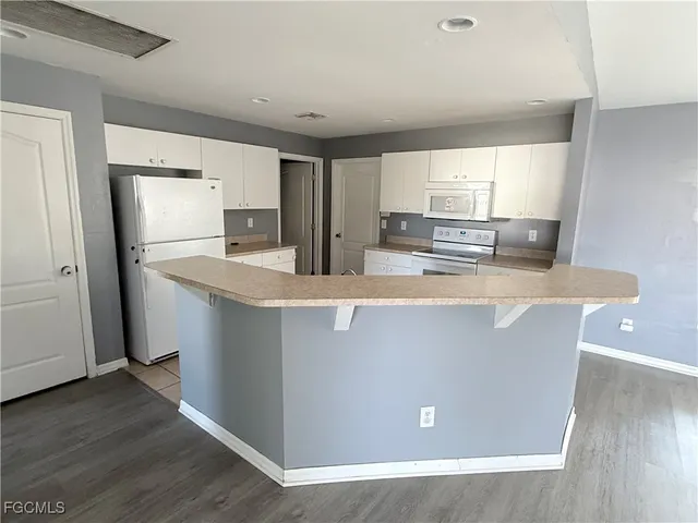 a view of a kitchen with wooden floor