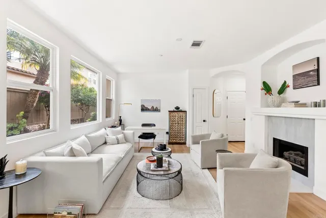a living room with furniture and a fireplace