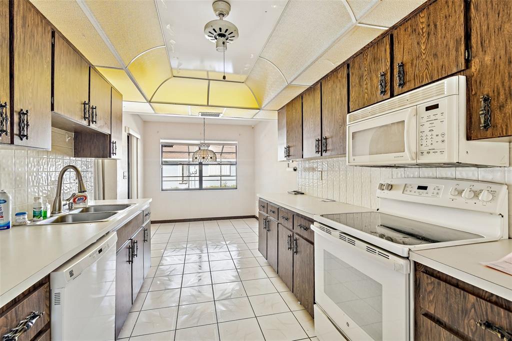 2051 Laredo Avenue Spring Hill, FL 34608 - Photo 16 of 76 a kitchen with stainless steel appliances a sink a stove and cabinets