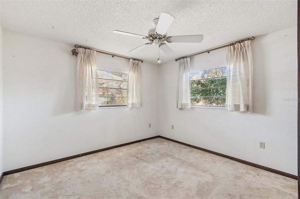 2051 Laredo Avenue Spring Hill, FL 34608 - Photo 24 of 76 an empty room with windows and fan
