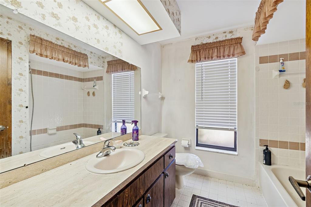 2051 Laredo Avenue Spring Hill, FL 34608 - Photo 27 of 76 a bathroom with a granite countertop sink and a mirror