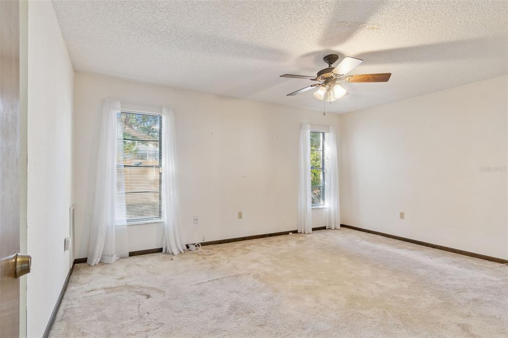 2051 Laredo Avenue Spring Hill, FL 34608 - Photo 36 of 76 an empty room with windows and fan