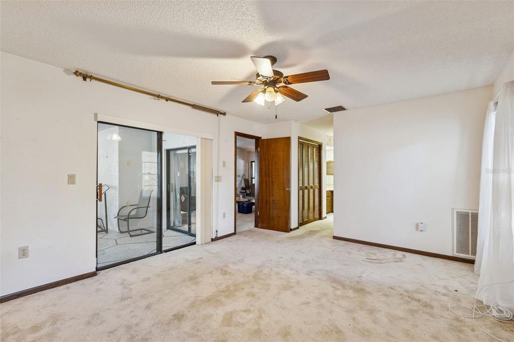 2051 Laredo Avenue Spring Hill, FL 34608 - Photo 38 of 76 an empty room with closet and a ceiling fan