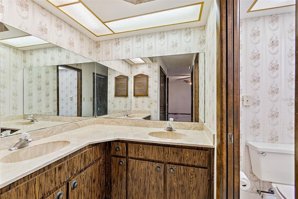 2051 Laredo Avenue Spring Hill, FL 34608 - Photo 42 of 76 a bathroom with a sink a mirror and a shower