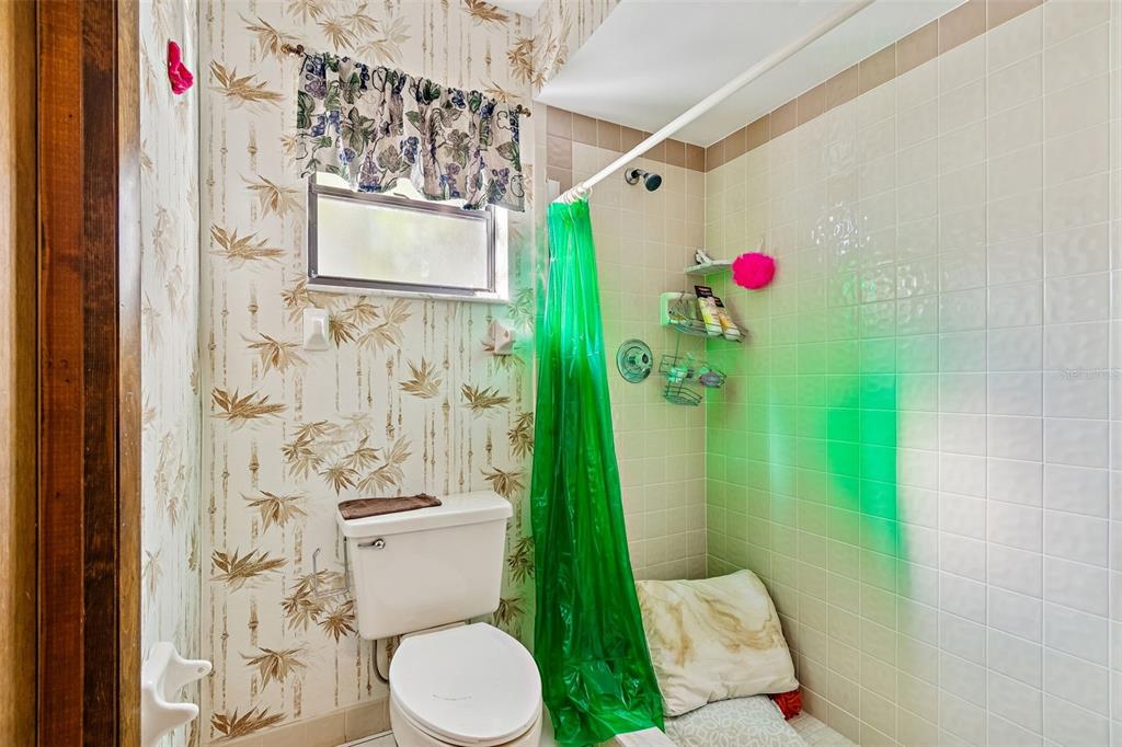 2051 Laredo Avenue Spring Hill, FL 34608 - Photo 46 of 76 a bathroom with a toilet and shower curtain