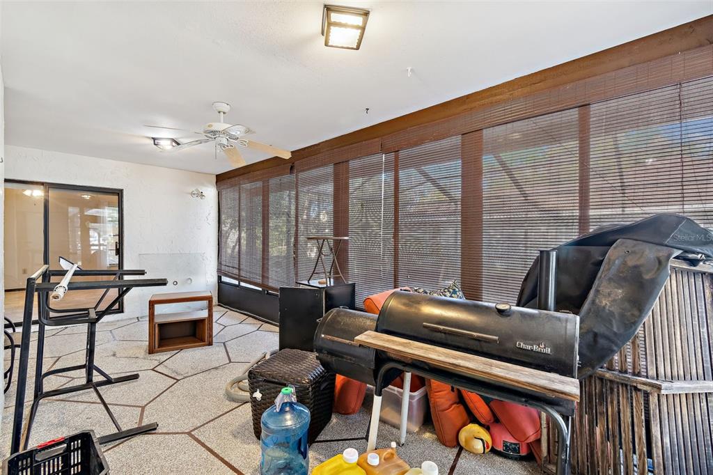 2051 Laredo Avenue Spring Hill, FL 34608 - Photo 48 of 76 a living room with furniture and a floor to ceiling window