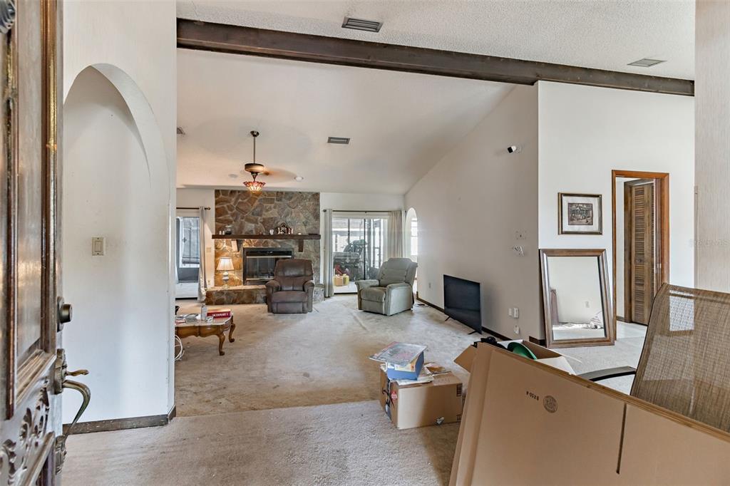 2051 Laredo Avenue Spring Hill, FL 34608 - Photo 7 of 76 a living room with furniture a fireplace and flat screen tv