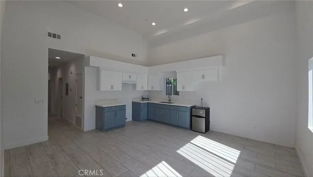 a large room with kitchen view