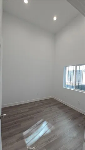 a view of staircase with white walls and white door