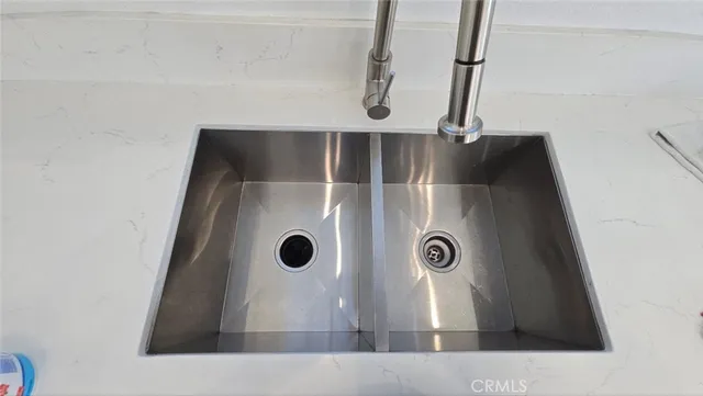 a kitchen with stainless steel appliances a refrigerator and a stove top oven