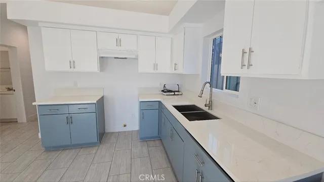 a kitchen with a sink and cabinets