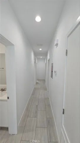 a spacious bathroom with a granite countertop sink a toilet a mirror and bathtub