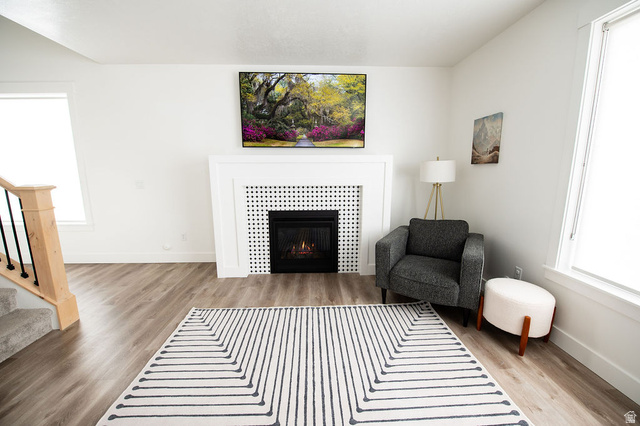 384 Ropelato Drive Nibley, UT 84321 - Photo 7 of 25 Living room featuring plenty of natural light, light wood-style floors, and a tiled fireplace