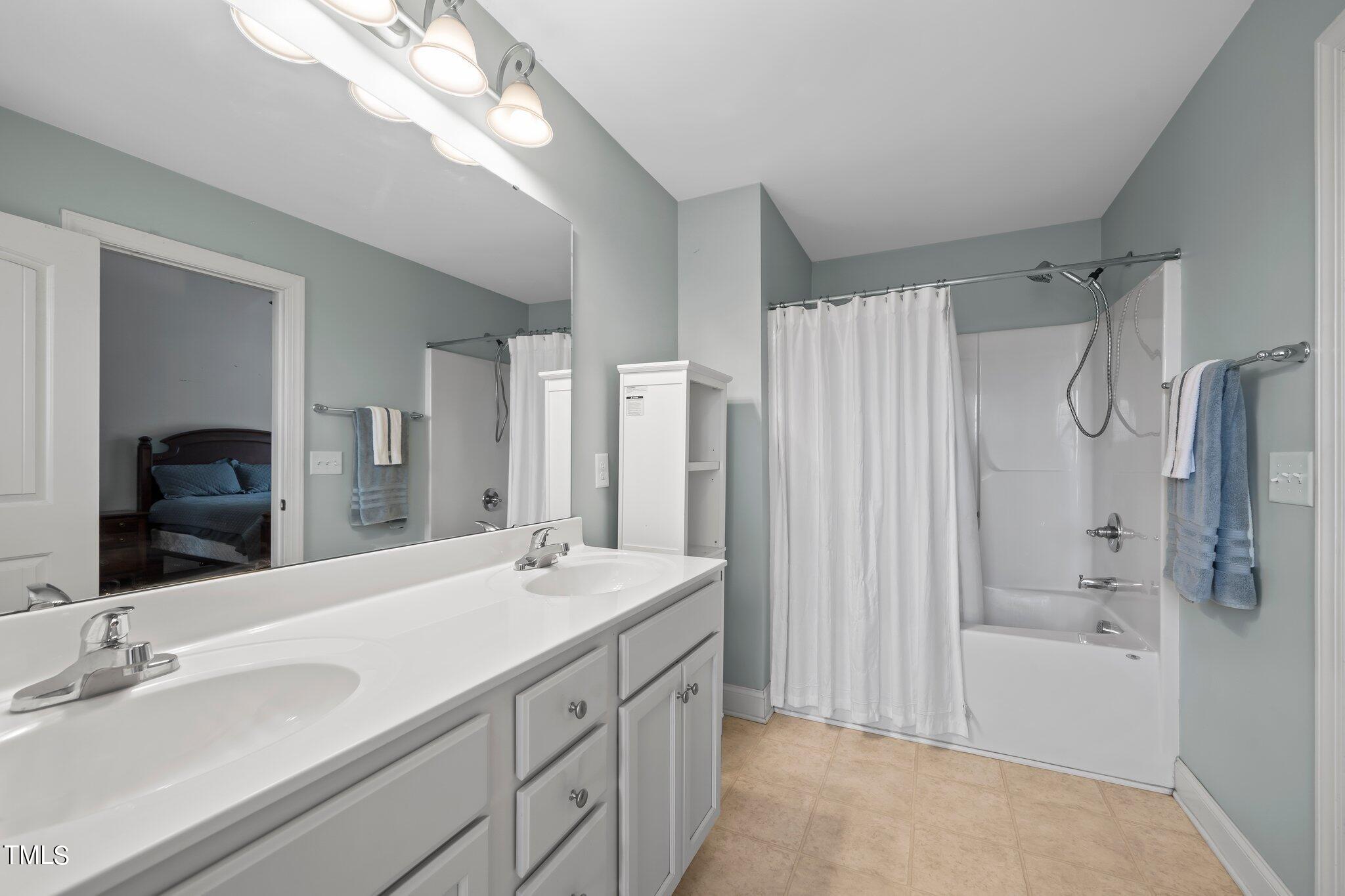 3195 Johnston County Road Angier, NC 27501 - Photo 20 of 31 a bathroom with a double vanity sink mirror double and shower