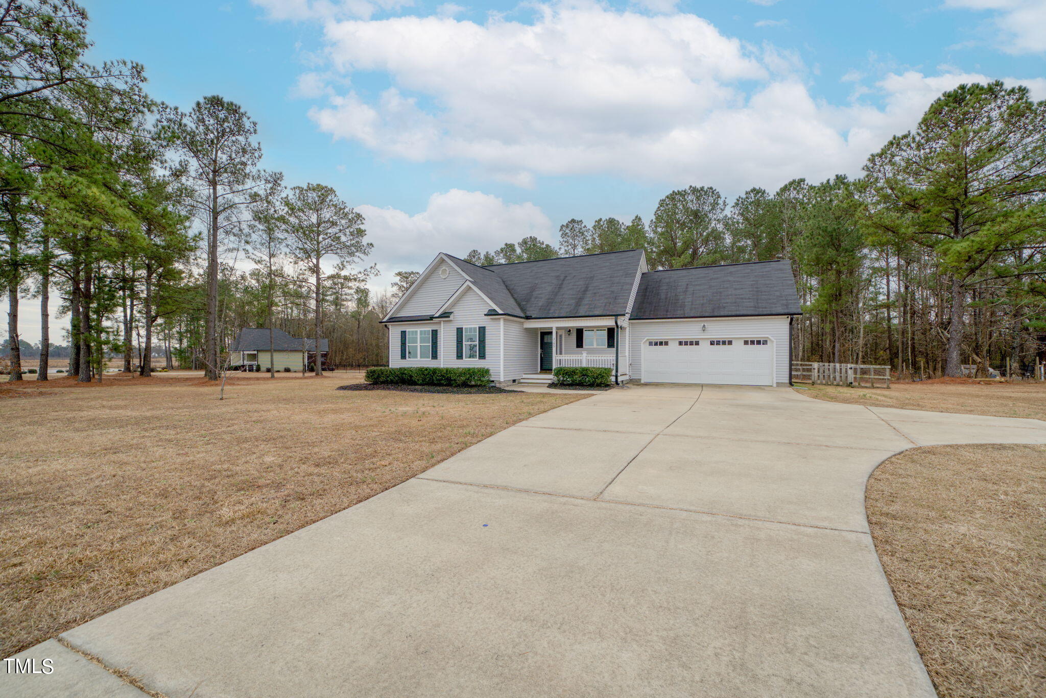 3195 Johnston County Road Angier, NC 27501 - Photo 2 of 31 a view of house with outdoor space and tall trees