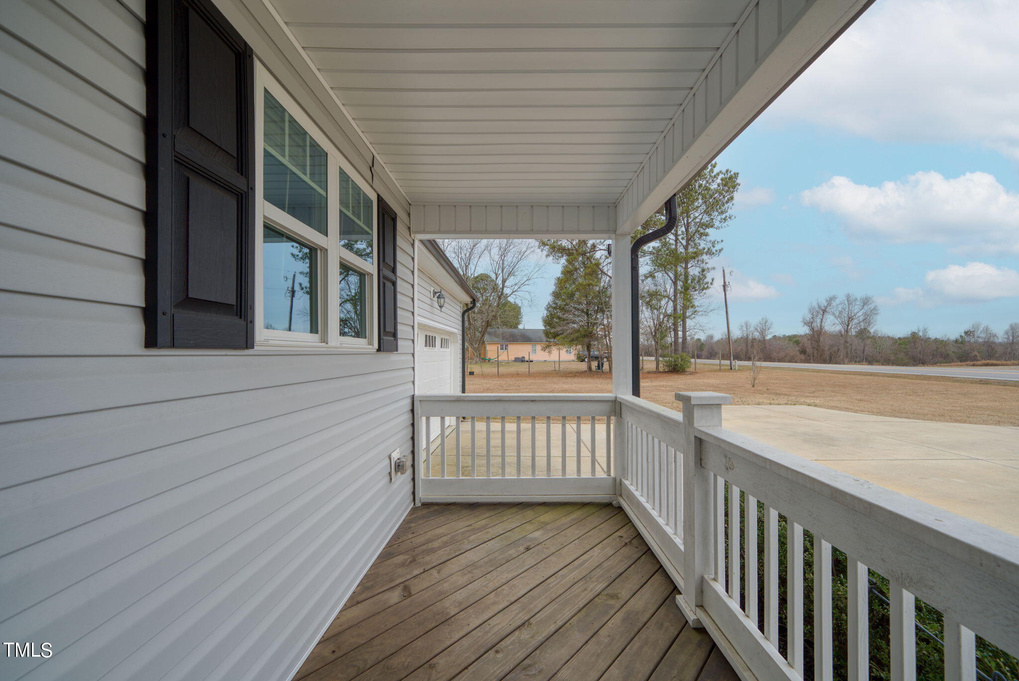 3195 Johnston County Road Angier, NC 27501 - Photo 3 of 31 a view of a balcony with wooden floor and fence