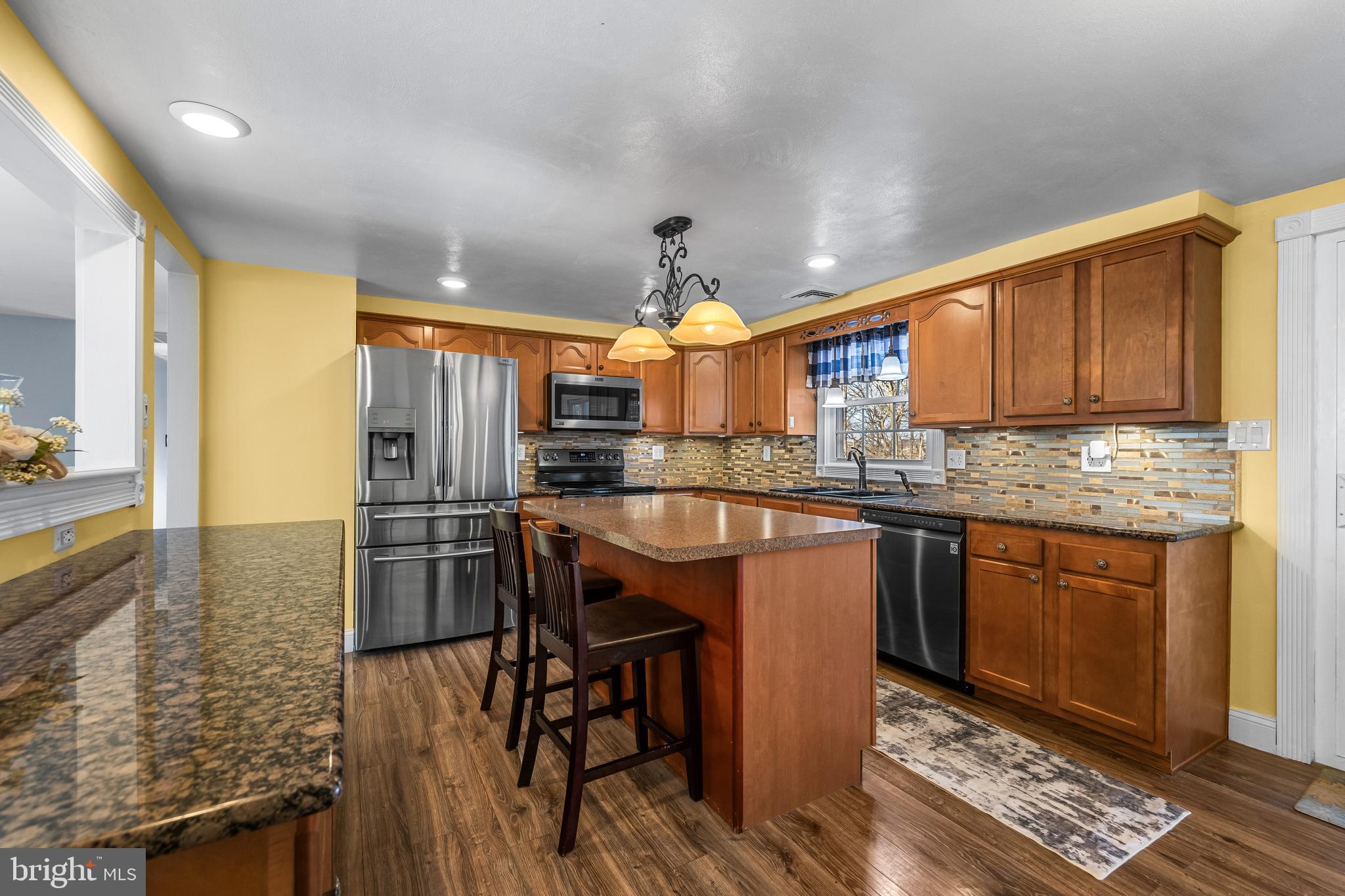 209 Forest Hills Road Red Lion, PA 17356 - Photo 12 of 43 a kitchen with stainless steel appliances granite countertop a stove a sink dishwasher and a refrigerator