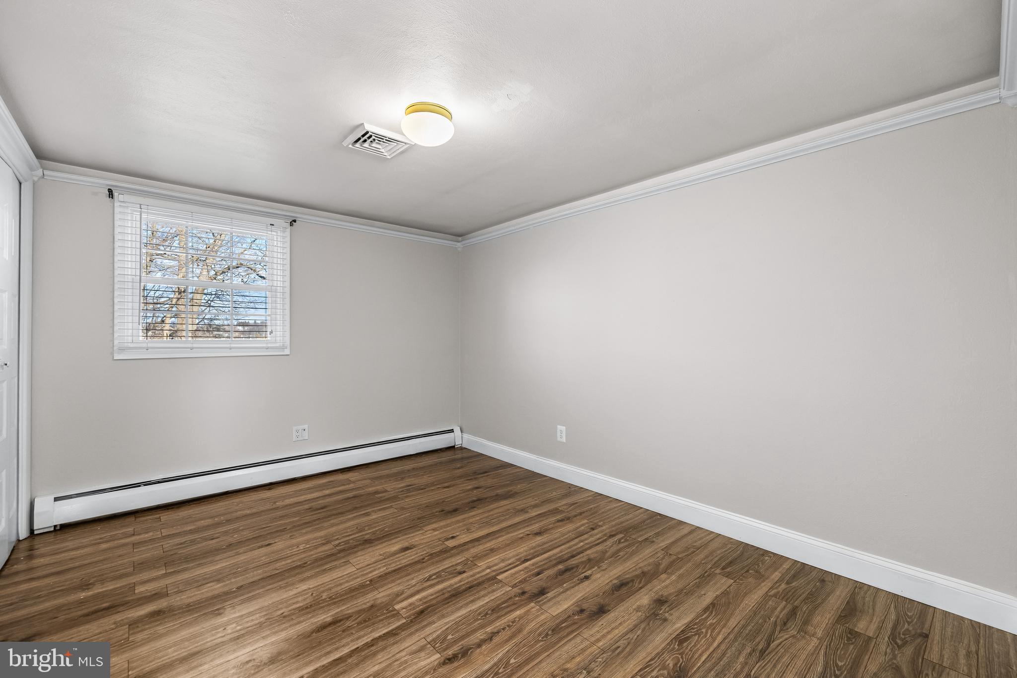 209 Forest Hills Road Red Lion, PA 17356 - Photo 14 of 43 an empty room with wooden floor and windows
