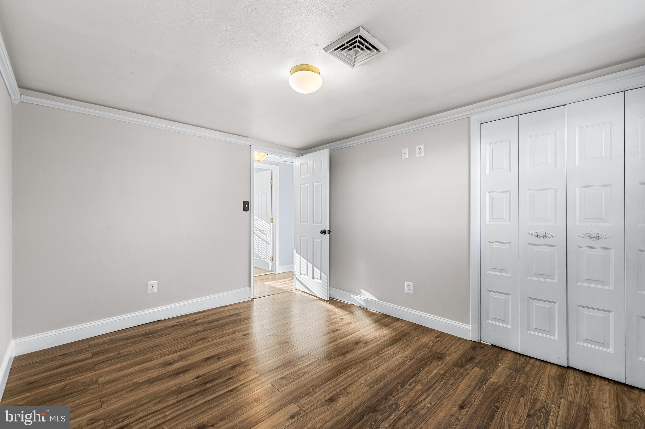 209 Forest Hills Road Red Lion, PA 17356 - Photo 15 of 43 a view of an empty room with wooden floor