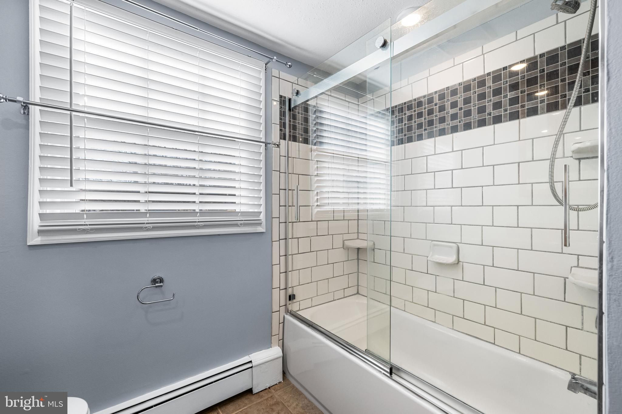 209 Forest Hills Road Red Lion, PA 17356 - Photo 17 of 43 a bathroom with a bathtub and next to a window