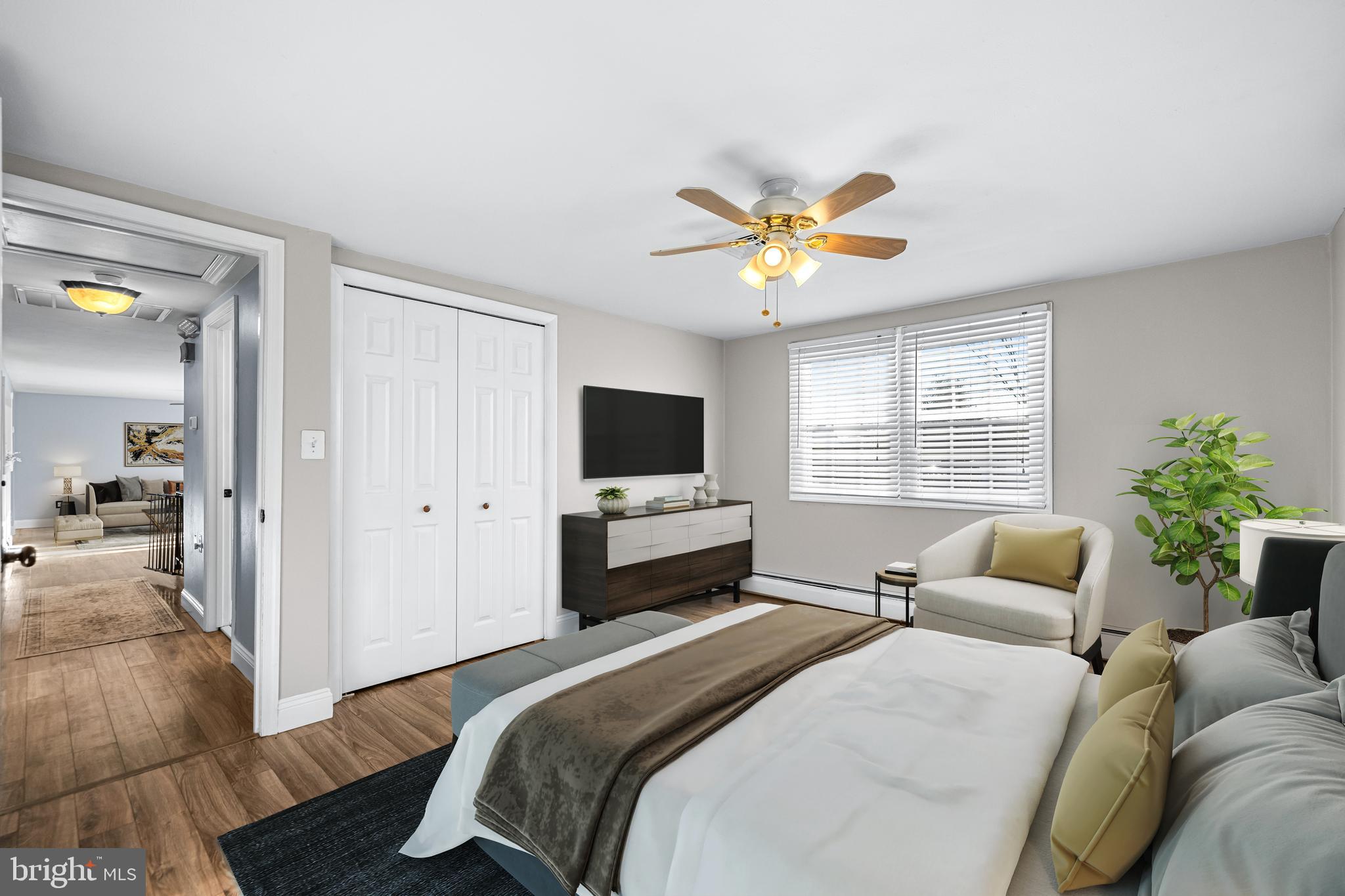 209 Forest Hills Road Red Lion, PA 17356 - Photo 21 of 43 a bedroom with a bed a couch and a flat screen tv