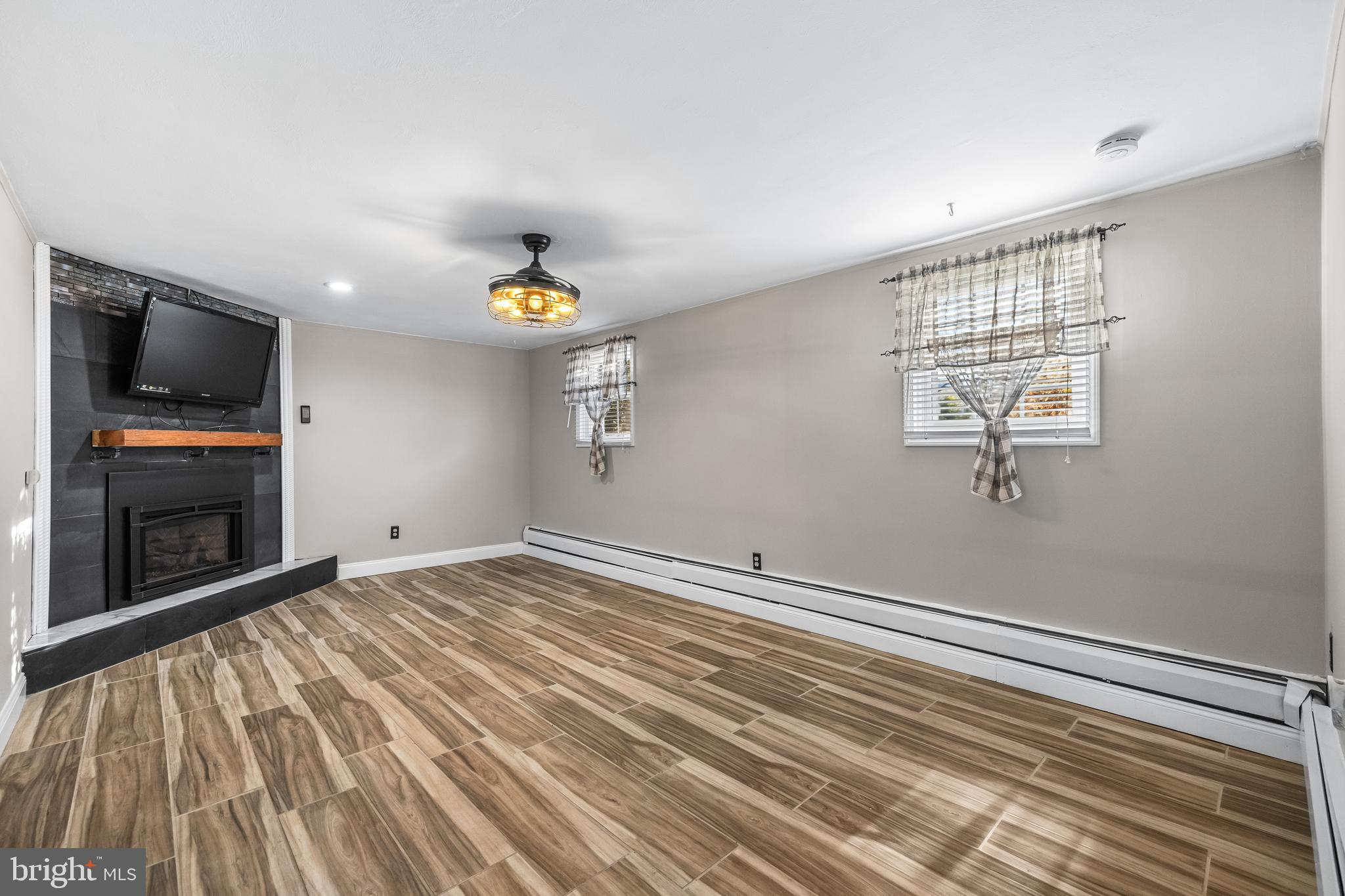 209 Forest Hills Road Red Lion, PA 17356 - Photo 23 of 43 a view of empty room with wooden floor and fan