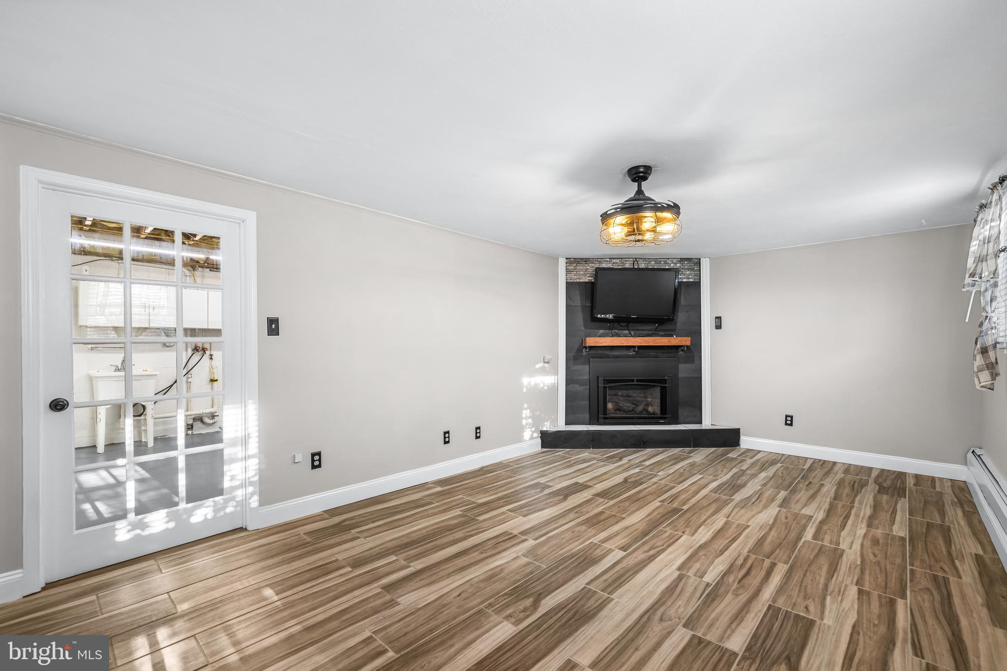 209 Forest Hills Road Red Lion, PA 17356 - Photo 24 of 43 a view of empty room with wooden floor and windows