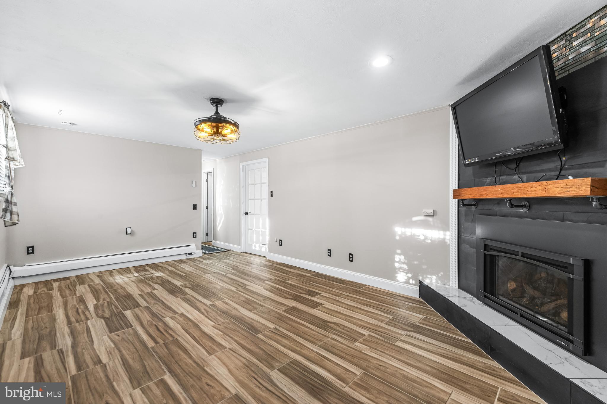209 Forest Hills Road Red Lion, PA 17356 - Photo 25 of 43 a view of empty room with wooden floor and fireplace