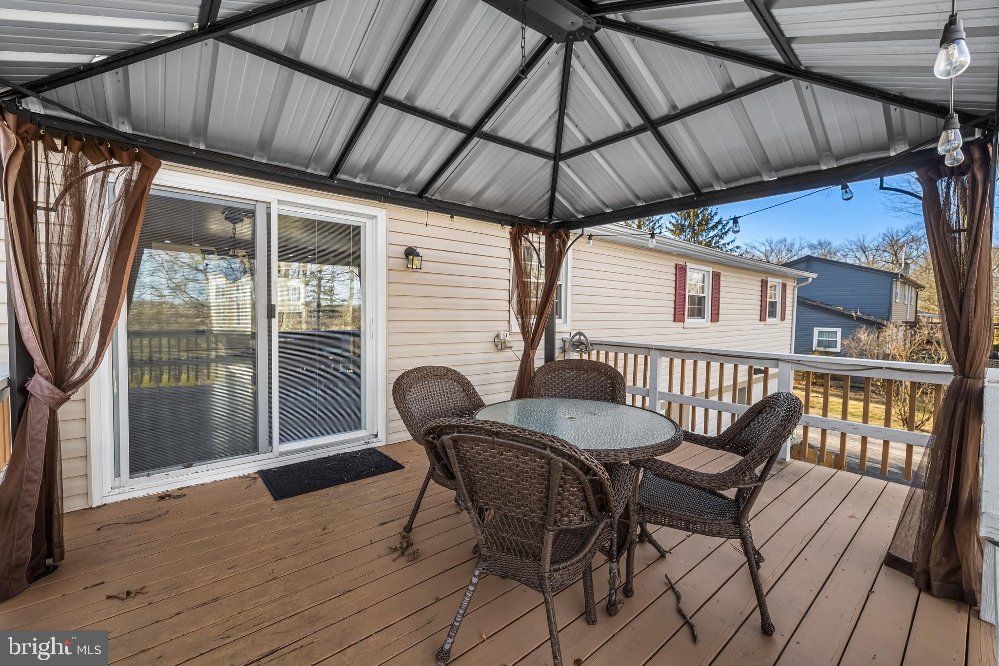 209 Forest Hills Road Red Lion, PA 17356 - Photo 39 of 43 a patio with wooden floor a yard a table and chairs