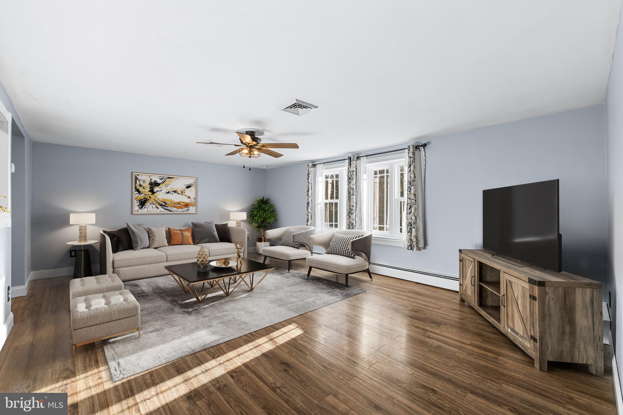 209 Forest Hills Road Red Lion, PA 17356 - Photo 6 of 43 a living room with furniture and a flat screen tv