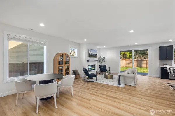 a dining room with furniture and wooden floor
