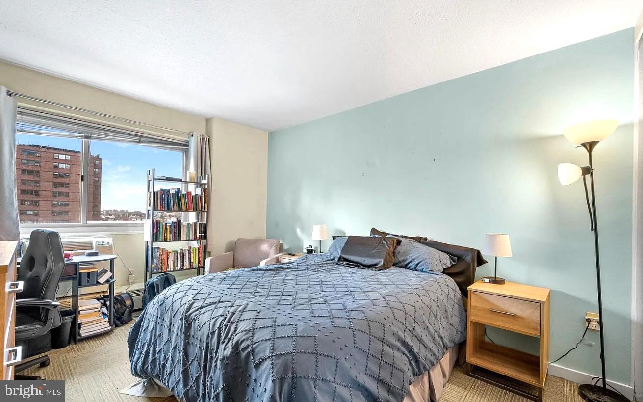 2101-17 Chestnut Street, Unit 910 Philadelphia, PA 19103 - Photo 6 of 9 a bedroom with a bed and dresser