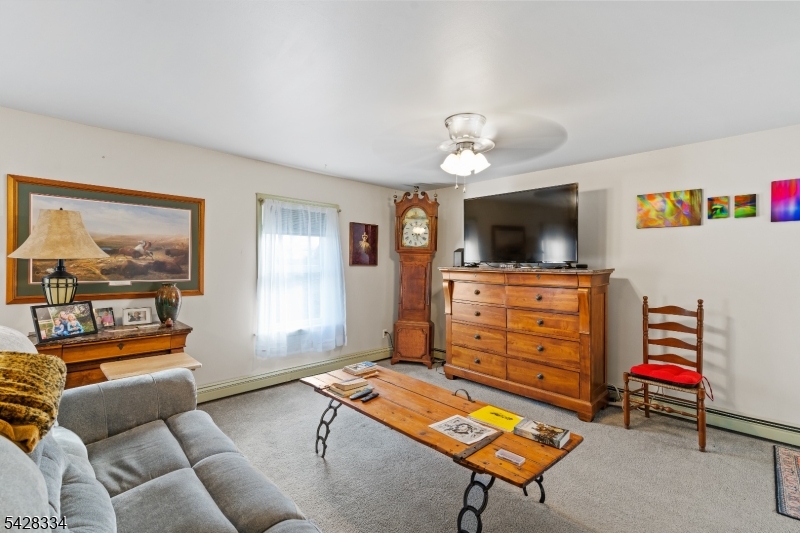 271 Quakertown Road, Unit 2 Pittstown, NJ 08867 - Photo 17 of 25 a living room with furniture and a flat screen tv