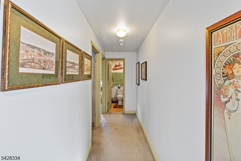 271 Quakertown Road, Unit 2 Pittstown, NJ 08867 - Photo 19 of 25 a view of a hallway with wooden floor and staircase