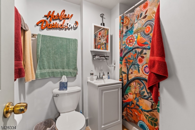 271 Quakertown Road, Unit 2 Pittstown, NJ 08867 - Photo 20 of 25 a bathroom with a sink a toilet and a shower curtain