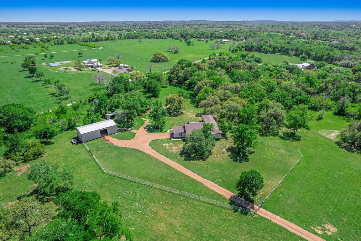 an aerial view of green landscape with trees houses and mountain view