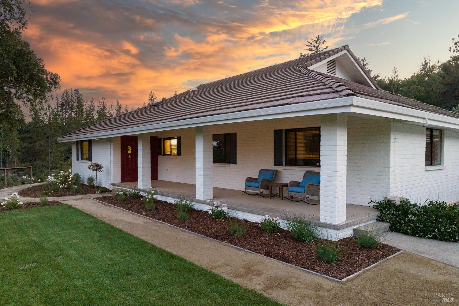 875 White Cottage Road North Angwin, CA 94508 - Photo 32 of 59 a front view of a house with a yard outdoor seating and garage