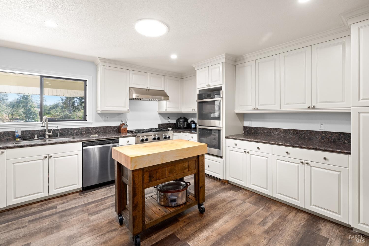 875 White Cottage Road North Angwin, CA 94508 - Photo 36 of 59 a kitchen with granite countertop a sink a stove and cabinets