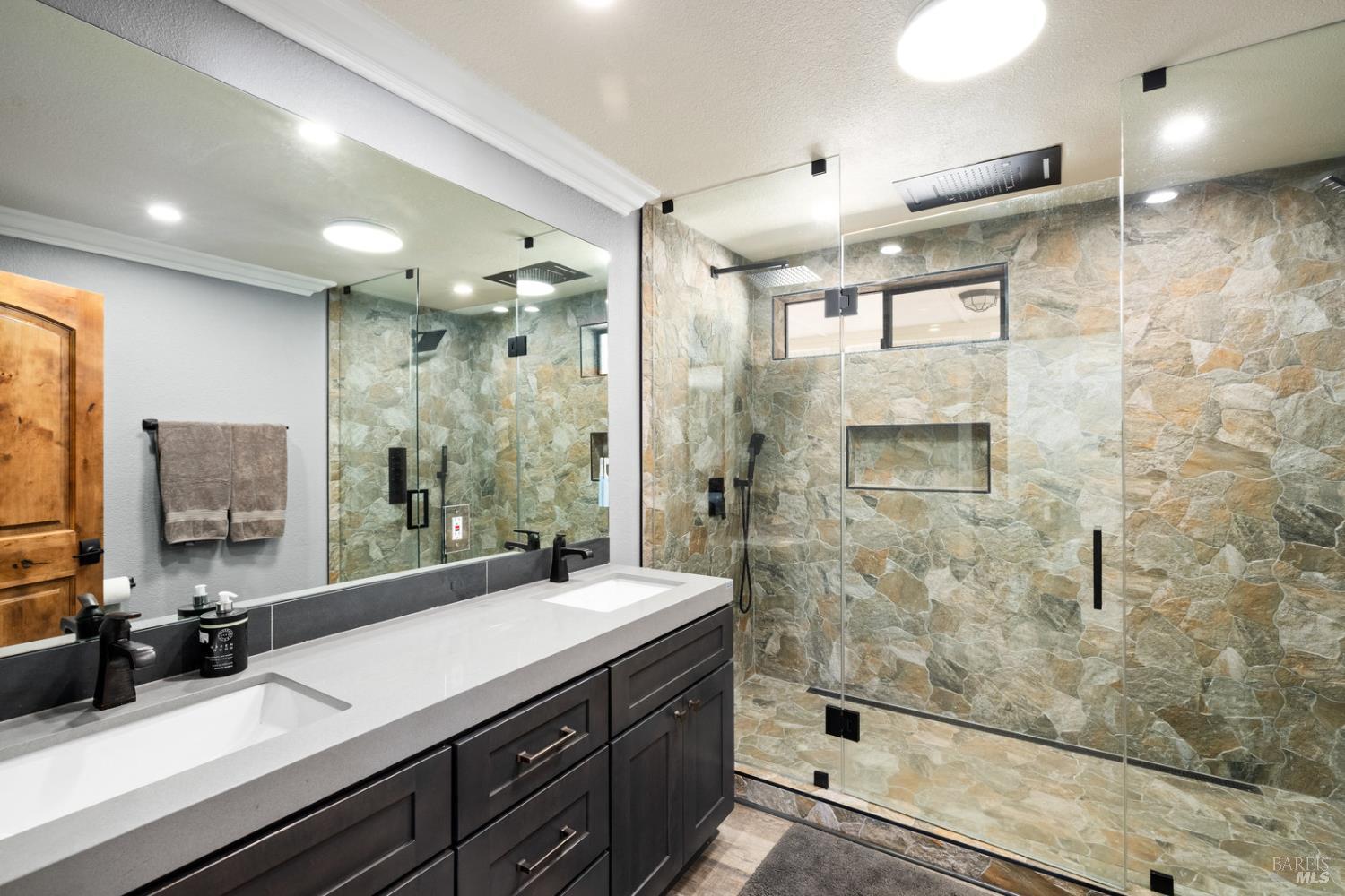 875 White Cottage Road North Angwin, CA 94508 - Photo 42 of 59 a bathroom with a double vanity sink a large mirror and shower
