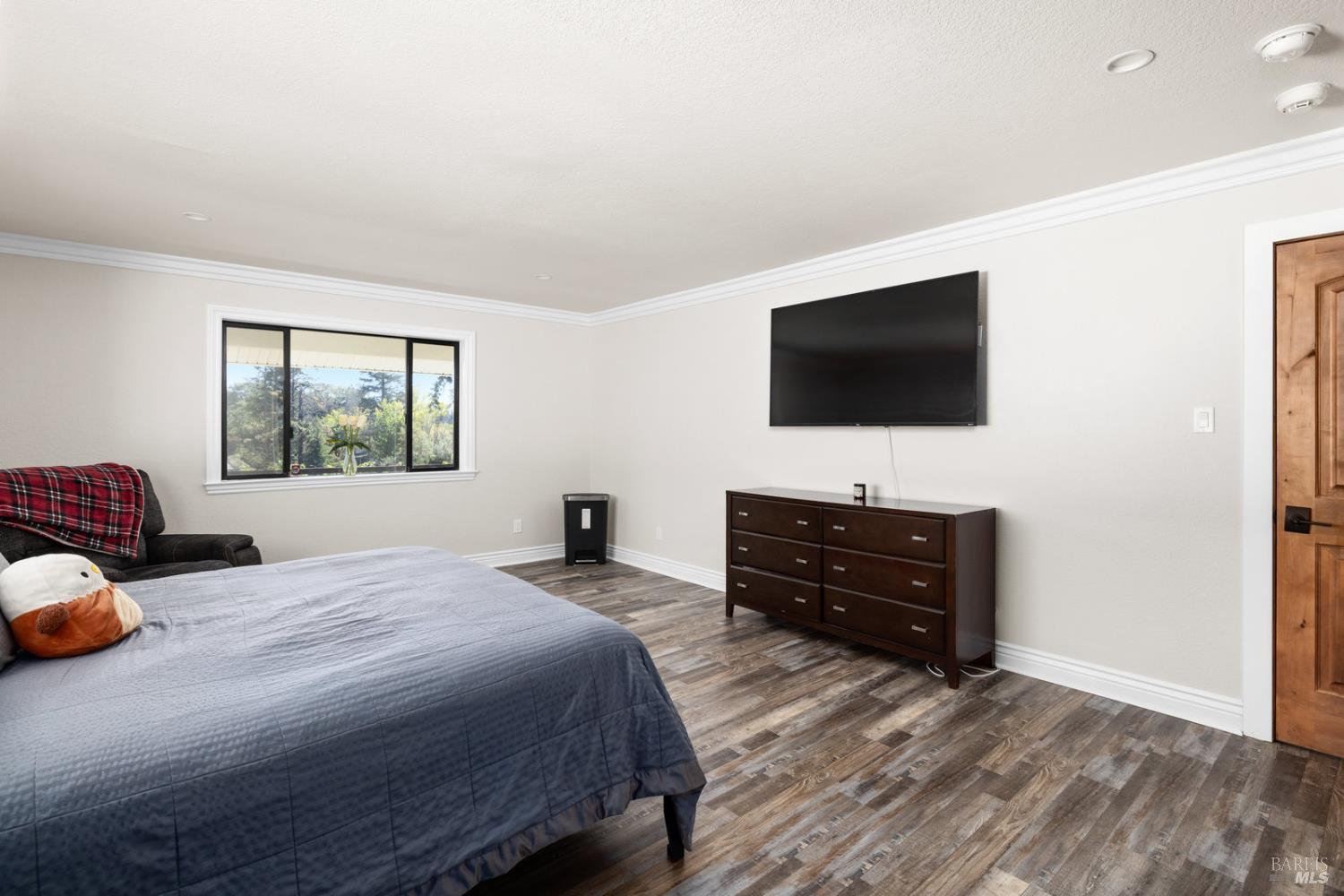 875 White Cottage Road North Angwin, CA 94508 - Photo 44 of 59 a bedroom with a bed and a flat screen television