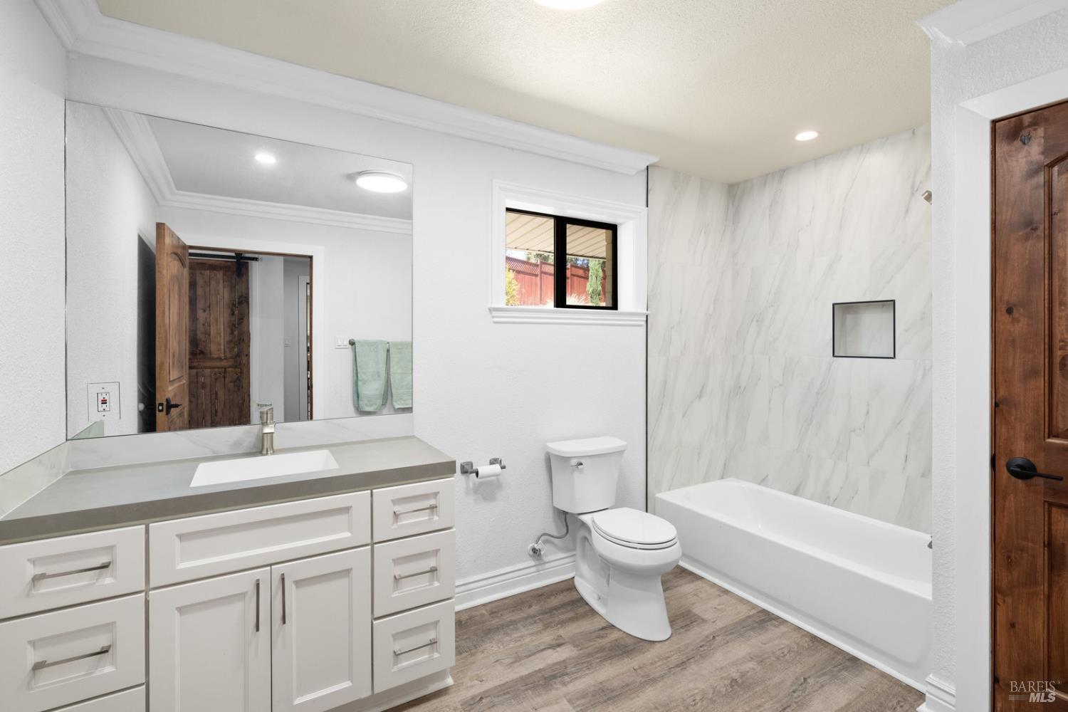 875 White Cottage Road North Angwin, CA 94508 - Photo 45 of 59 a spacious bathroom with a granite countertop sink toilet a large mirror a bathtub and shower