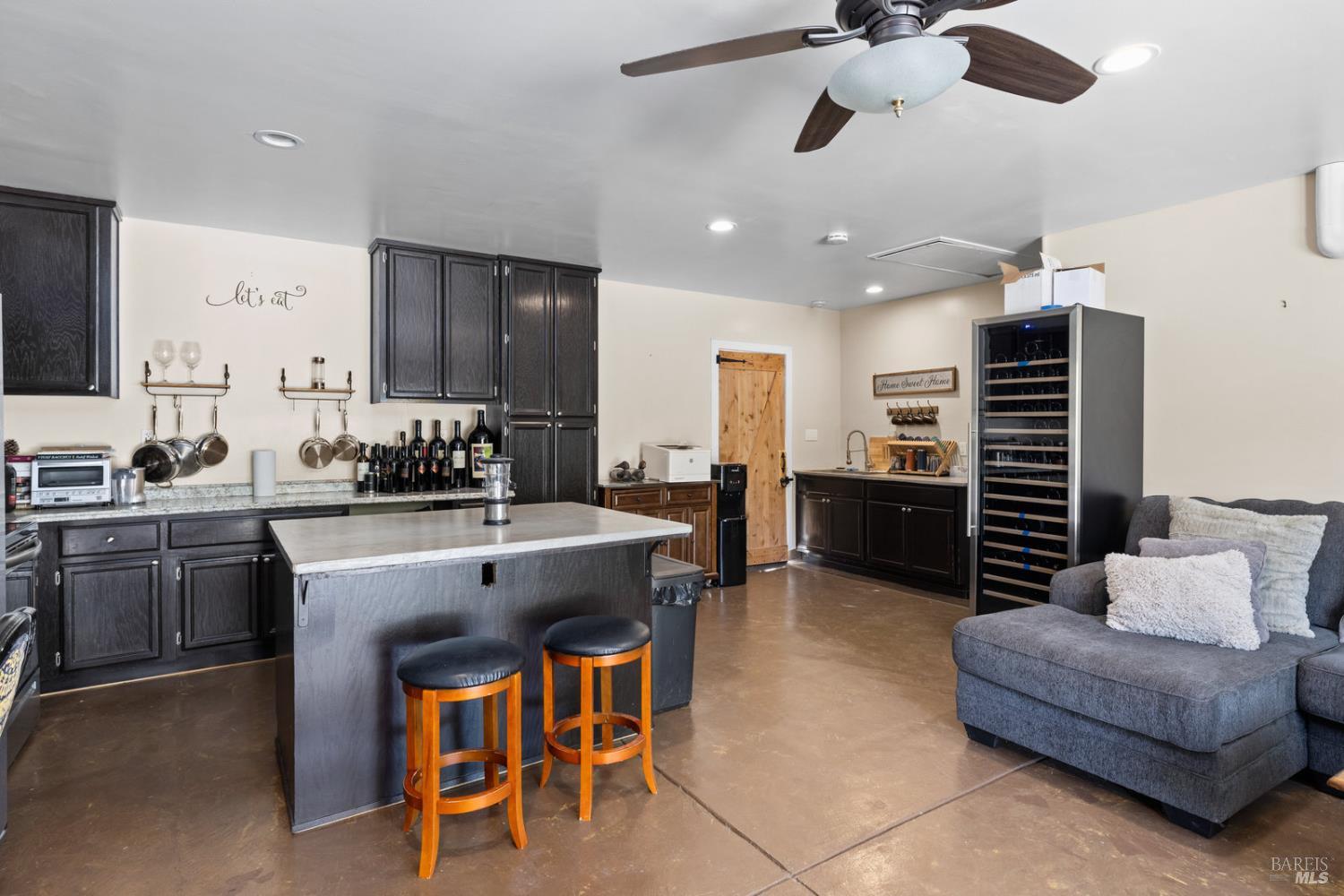 875 White Cottage Road North Angwin, CA 94508 - Photo 49 of 59 a large white kitchen with a table chairs and a refrigerator