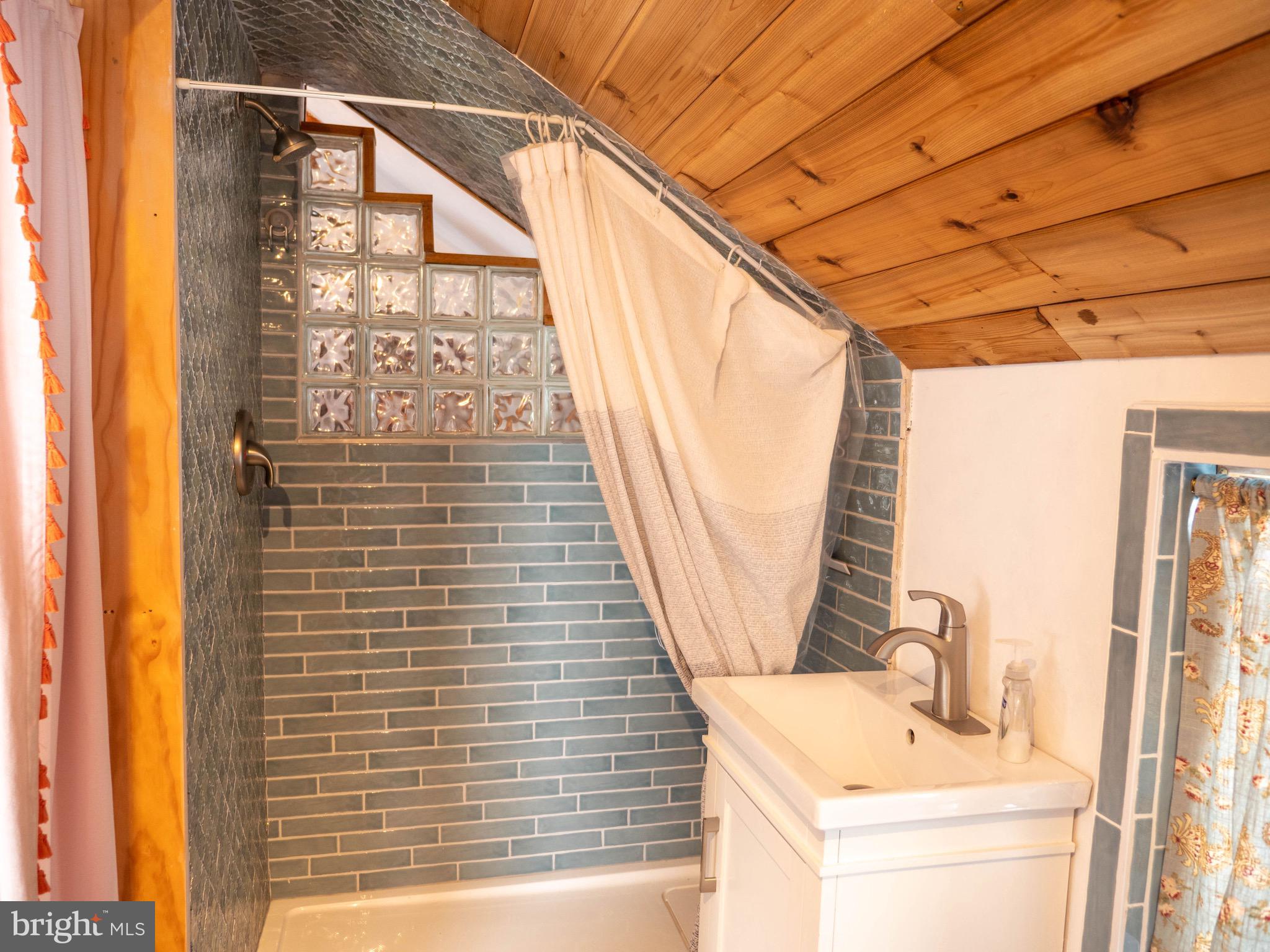 20800 Bivalve Wharf Road Bivalve, MD 21865 - Photo 22 of 31 a bathroom with a sink a mirror and next to a window