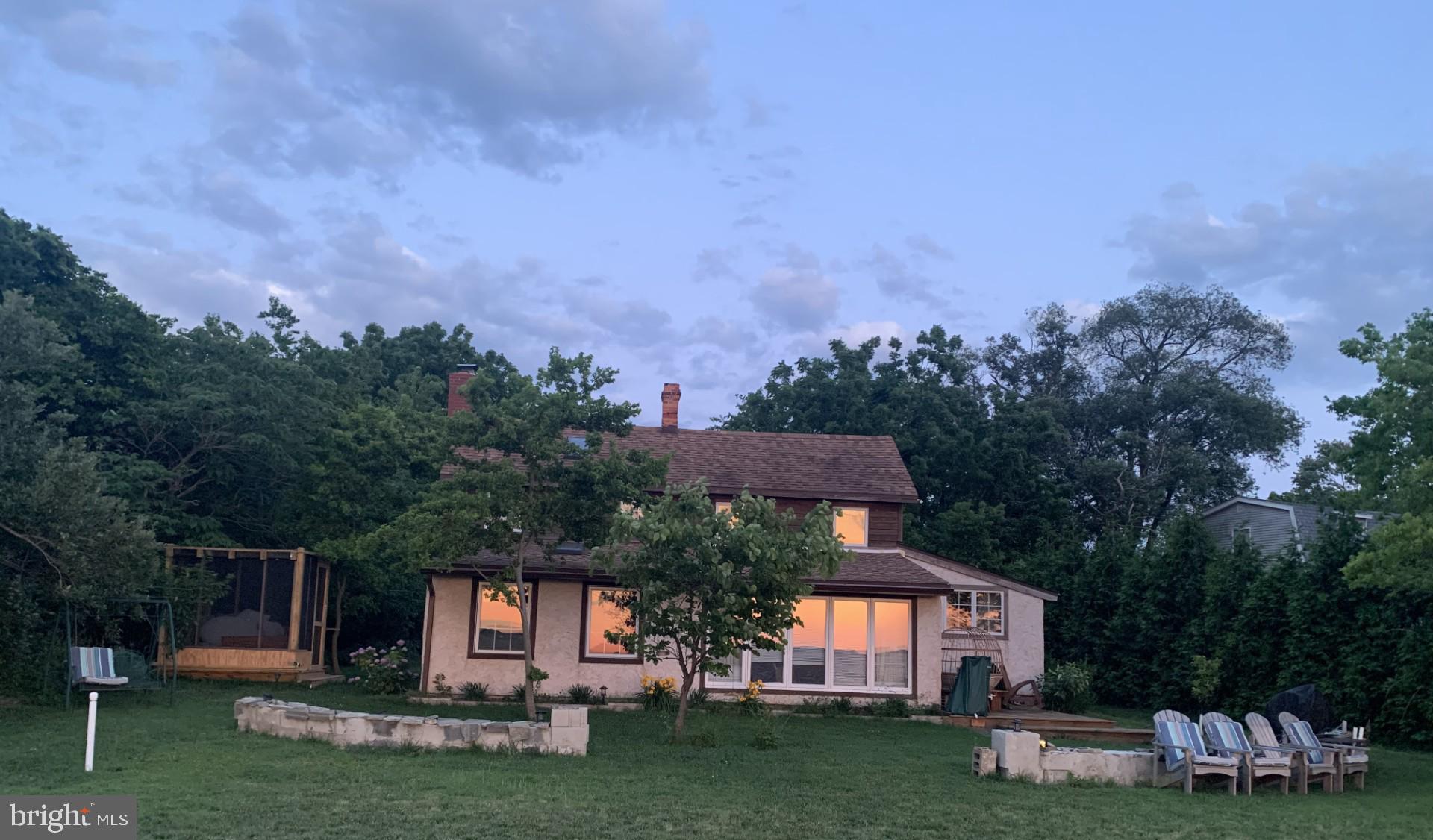 20800 Bivalve Wharf Road Bivalve, MD 21865 - Photo 28 of 31 a front view of a house with a garden and a tree